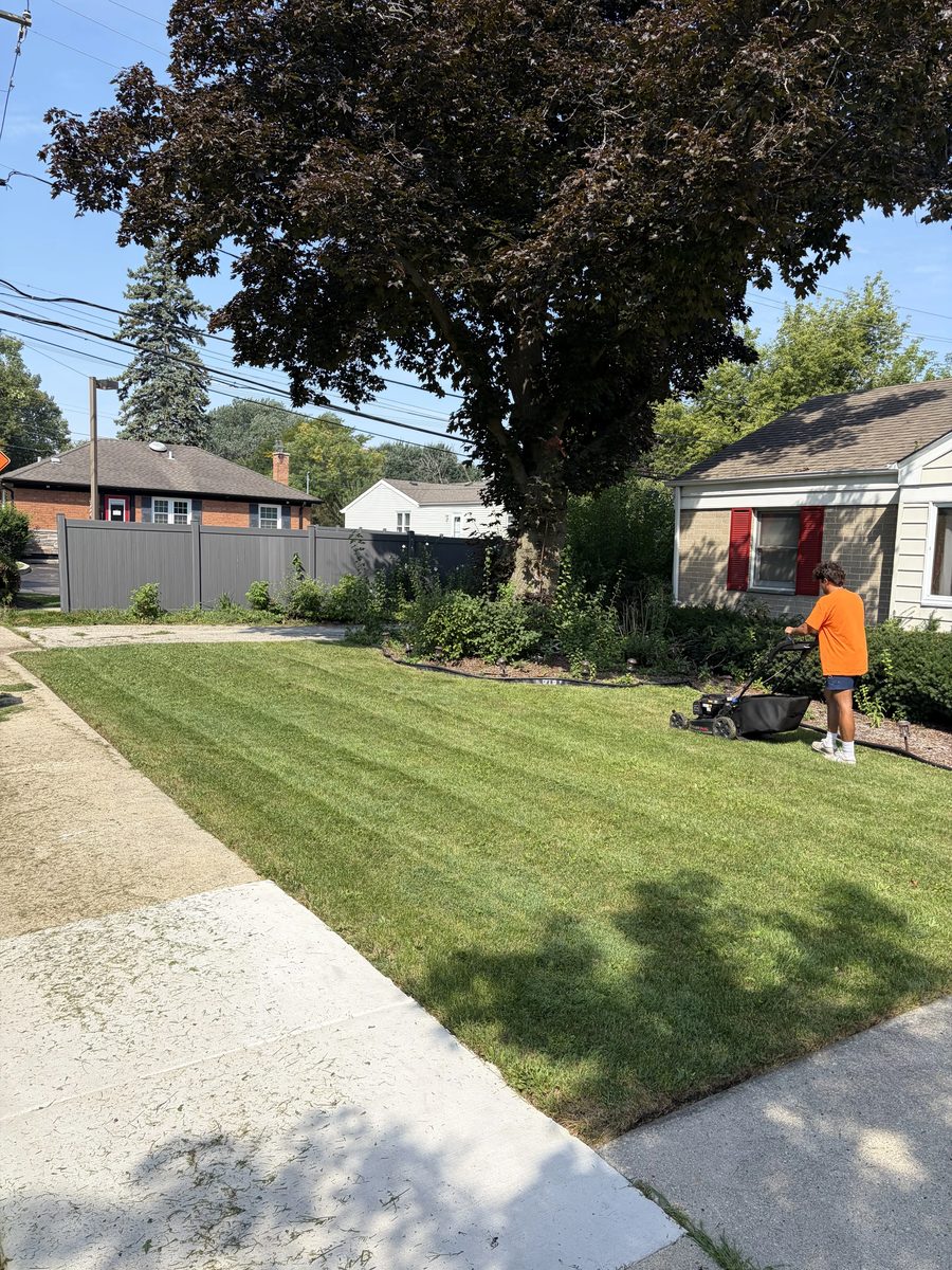 Moe Maintenance crew lawn care and striping on Chicago South Side residential property